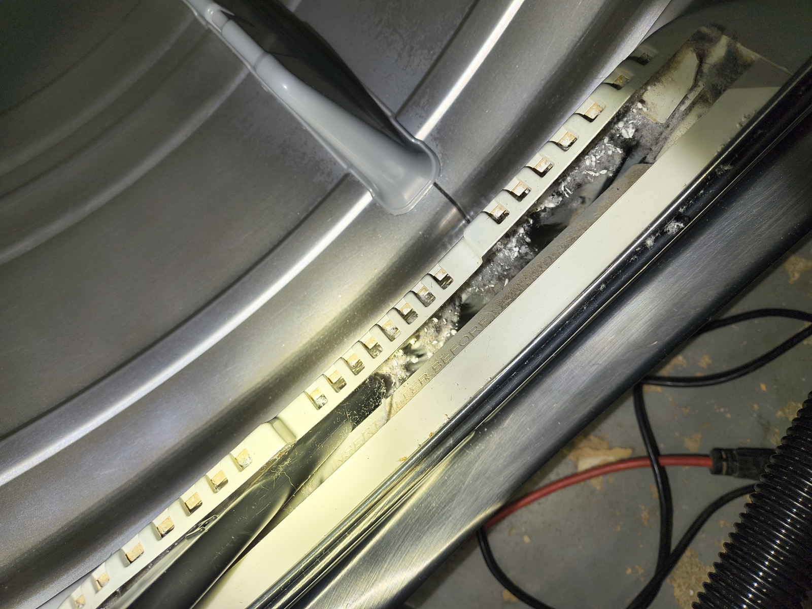 Lint buildup inside dryer lint trap cavity before cleaning